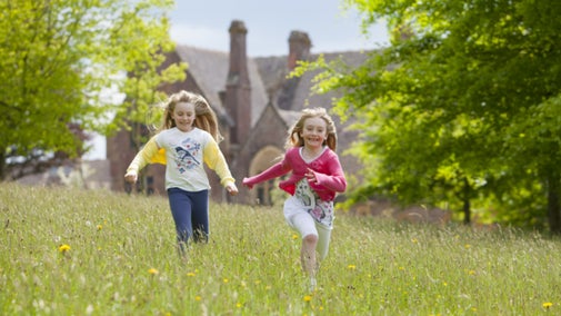 Children playing in the gardens at Knightshayes, Devon.